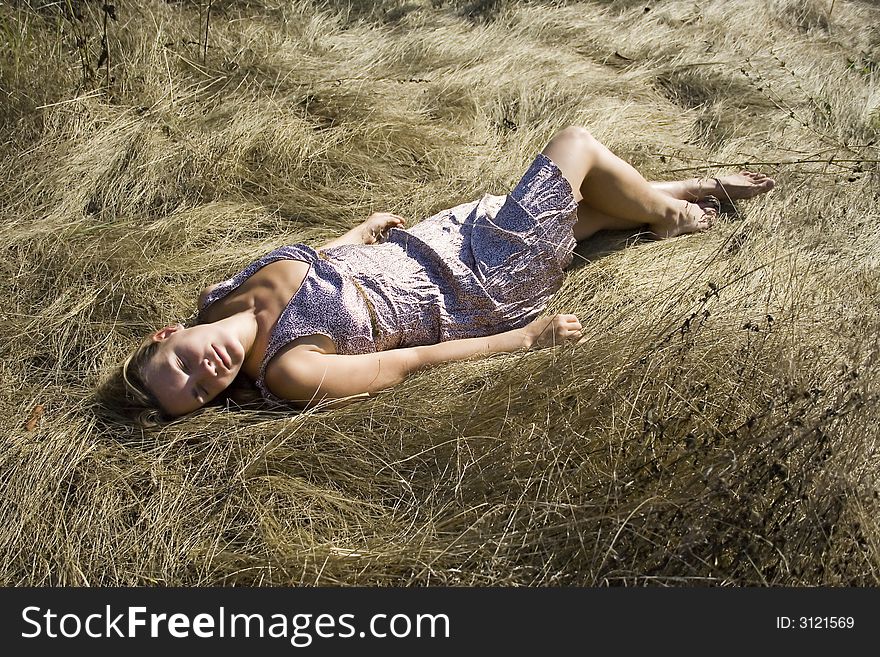The Girl Lays On A Grass