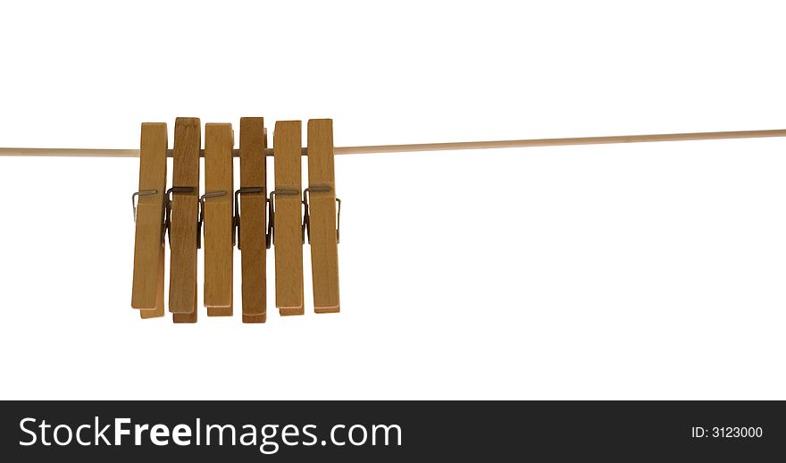 Wooden pegs hanging from a rope against white background