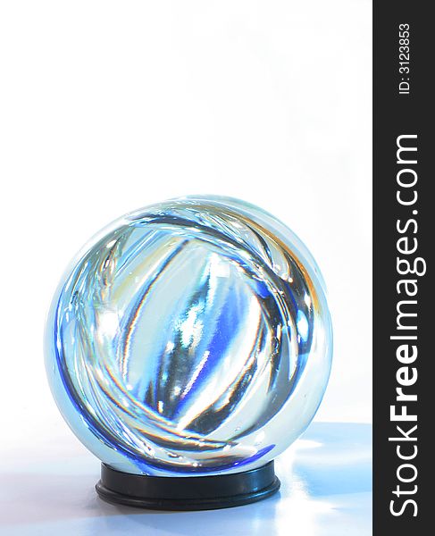 Crystal ball blue light within against white. Crystal ball blue light within against white