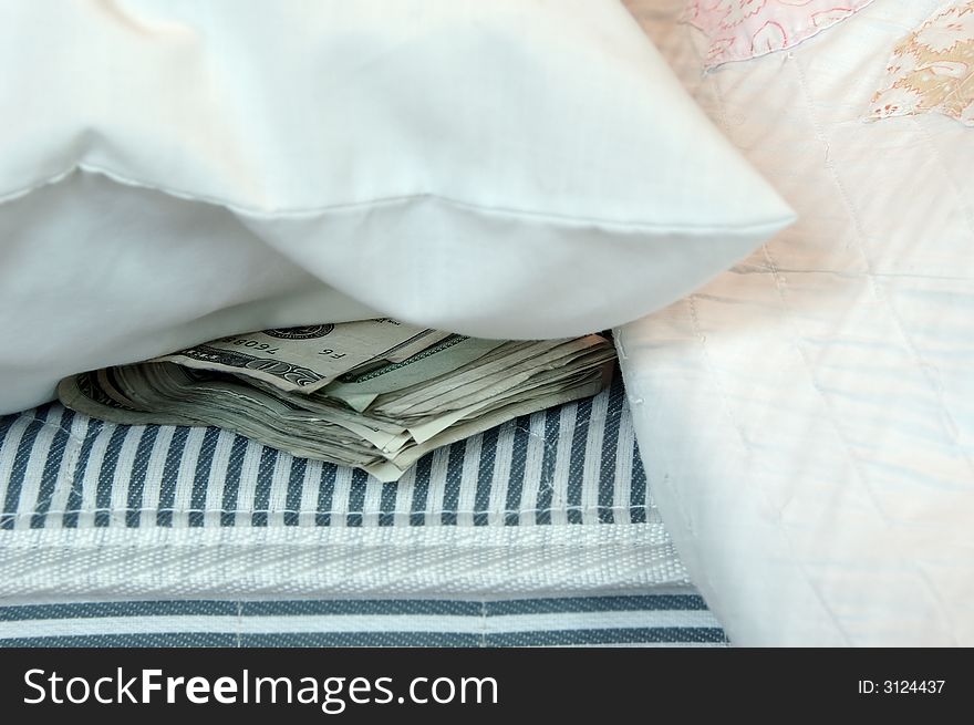 A roll of money tucked in a mattress for safekeeping. A roll of money tucked in a mattress for safekeeping.