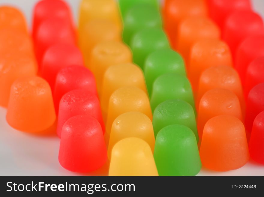 Colorful gummy candy in a line on white. Colorful gummy candy in a line on white