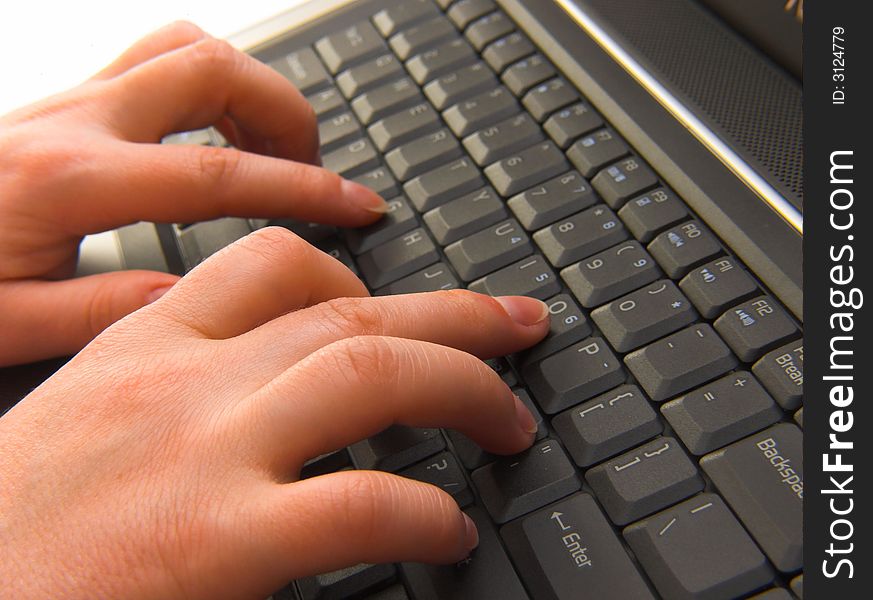 A businesswoman typing on a laptop