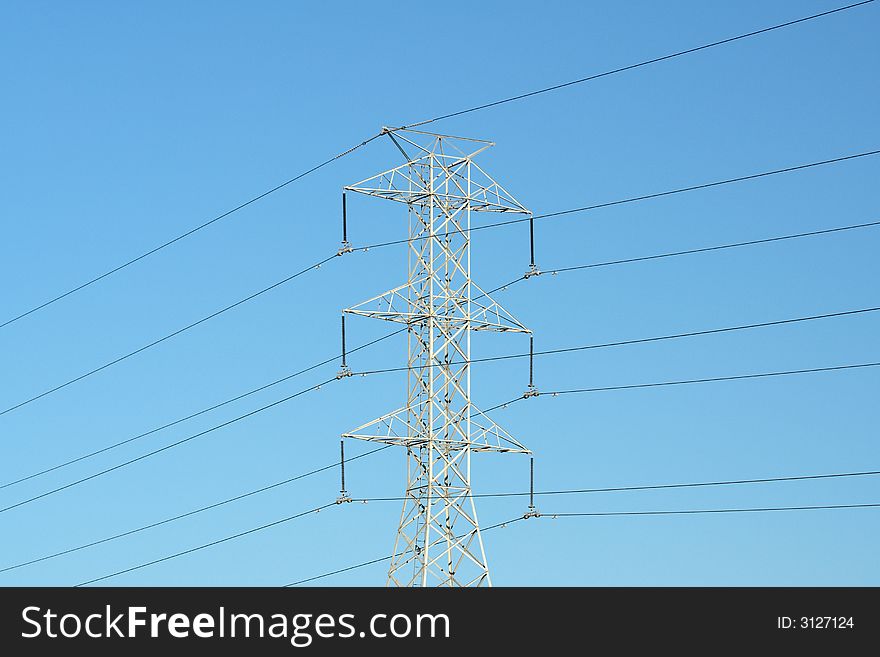 Electricity pylon against blue