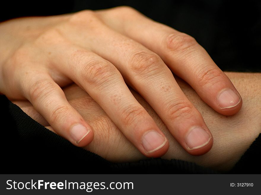 A photo of two woman's hands relaxed. A photo of two woman's hands relaxed