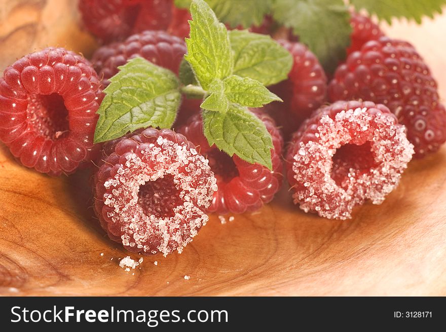 Plate with raspberries, sugar and mint. Plate with raspberries, sugar and mint