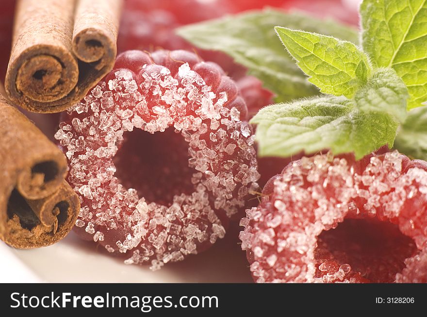 Plate with raspberries, sugar, cinnamon and mint. Plate with raspberries, sugar, cinnamon and mint