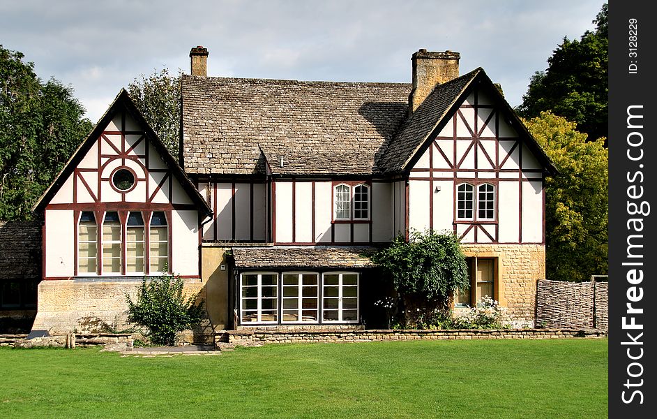 Timber Framed English Country House surrounded by a lawn and trees. Timber Framed English Country House surrounded by a lawn and trees