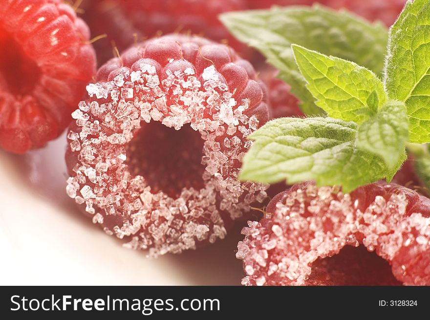 Plate with raspberries, sugar and mint. Plate with raspberries, sugar and mint