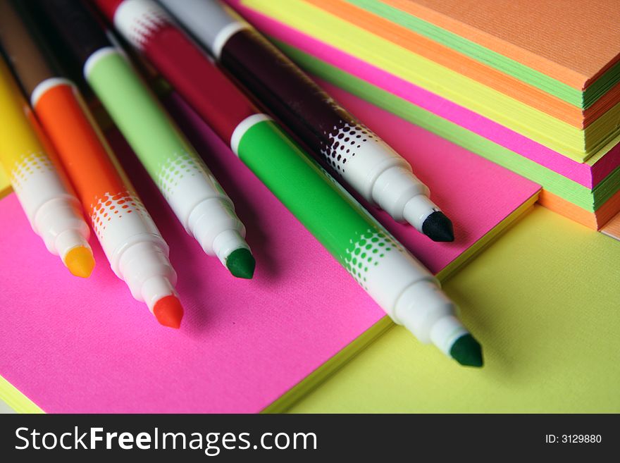 Colorful pencils over colored peaces of paper. Colorful pencils over colored peaces of paper