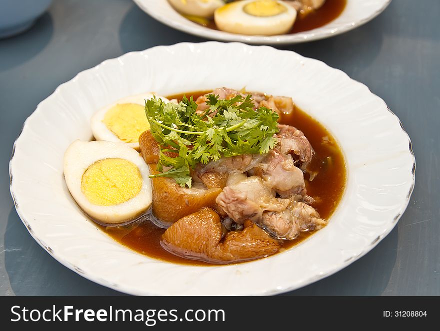 Stewed pork leg served with eggs