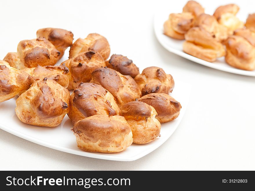Delisious profiteroles on the white plate . See my other works in portfolio.