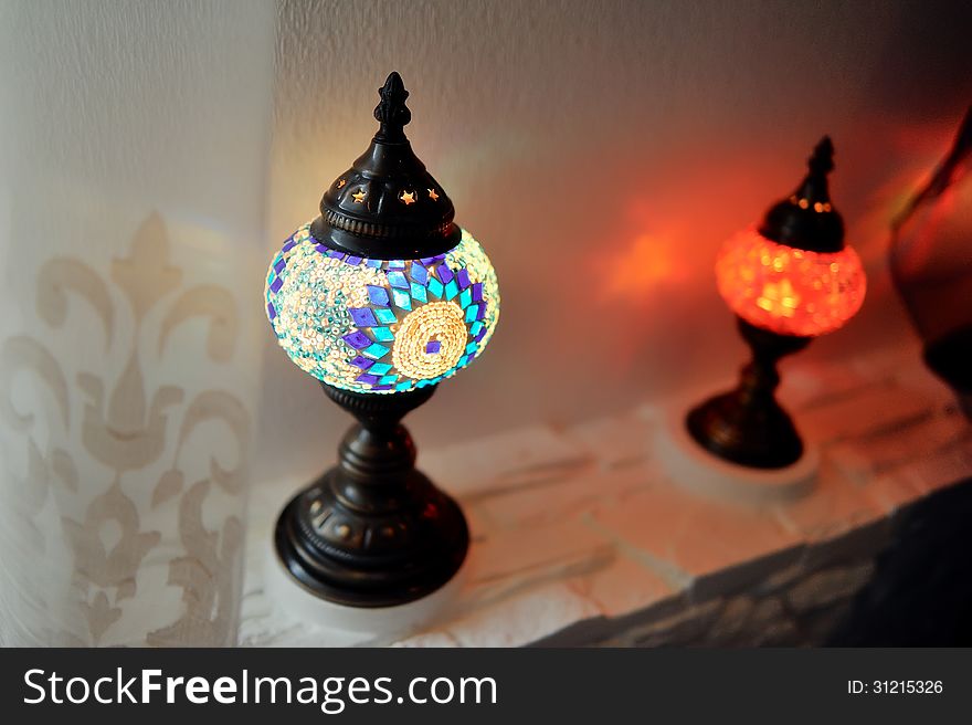 Close-up shows two curly, colored patterned lamp in oriental style. Close-up shows two curly, colored patterned lamp in oriental style
