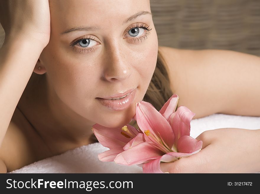 Beauty woman with flower getting spa treatment
