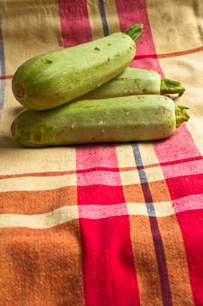 Wet Zucchini On A Colored Tablecloths. Royalty Free Stock Image