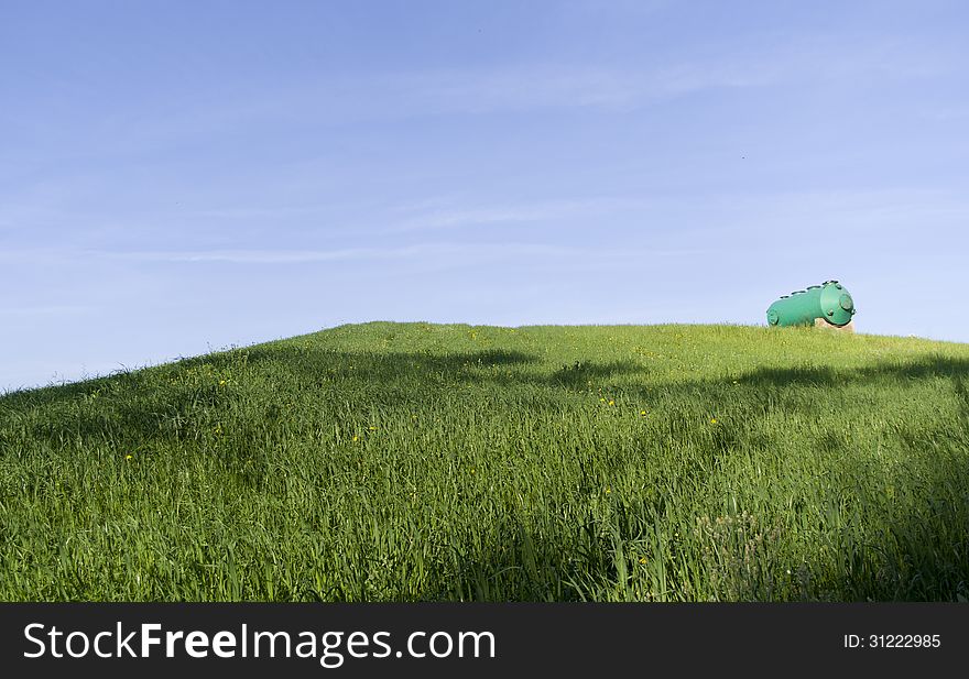 Green tank on a green hill