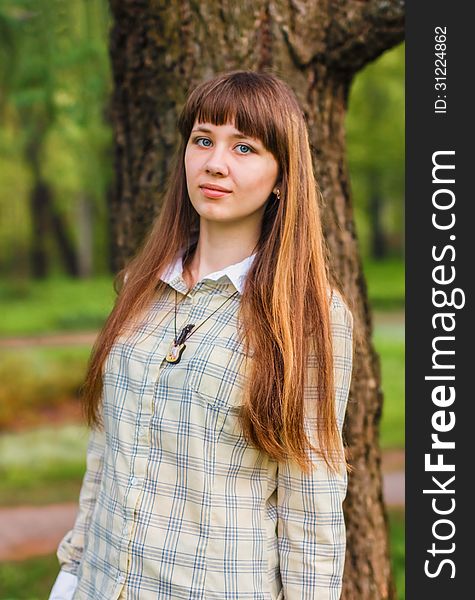 The girl poses on a green background of spring forest. 2013. The girl poses on a green background of spring forest. 2013