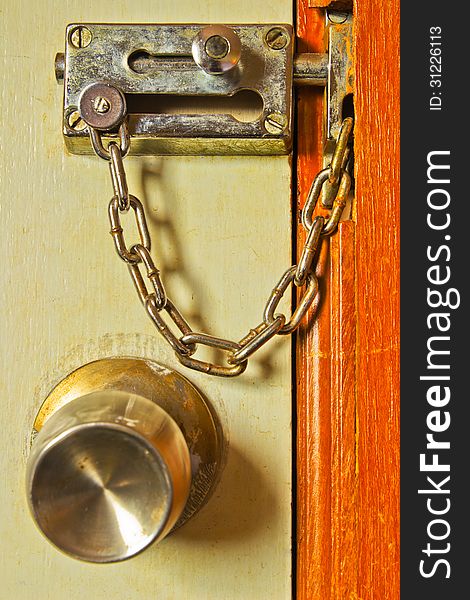 Old color wooden board with rusty chain side the door. Old color wooden board with rusty chain side the door.