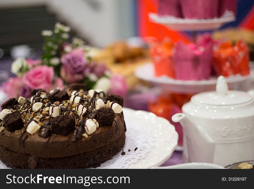 Chocolate cake display with teapot