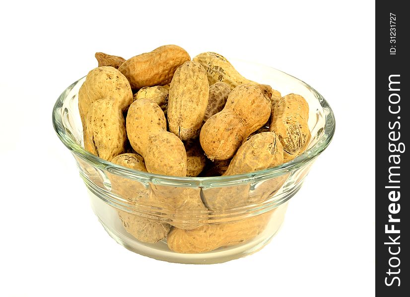 A glass bowl of peanuts on a white background.