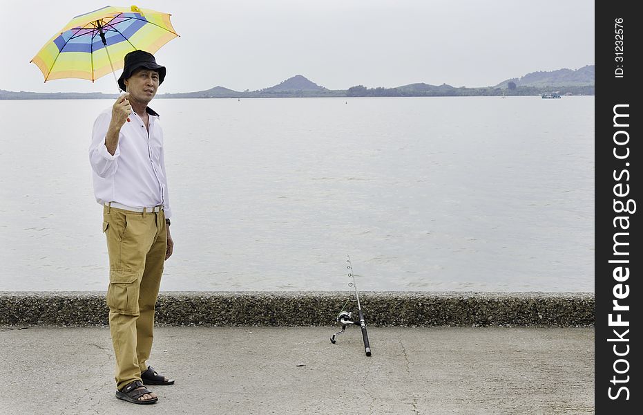 Senior fisherman catches a fish in the sea