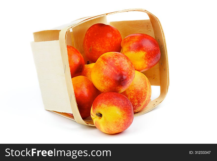 Heap of Perfect Ripe Nectarines Scattered of Basket closeup isolated on white background