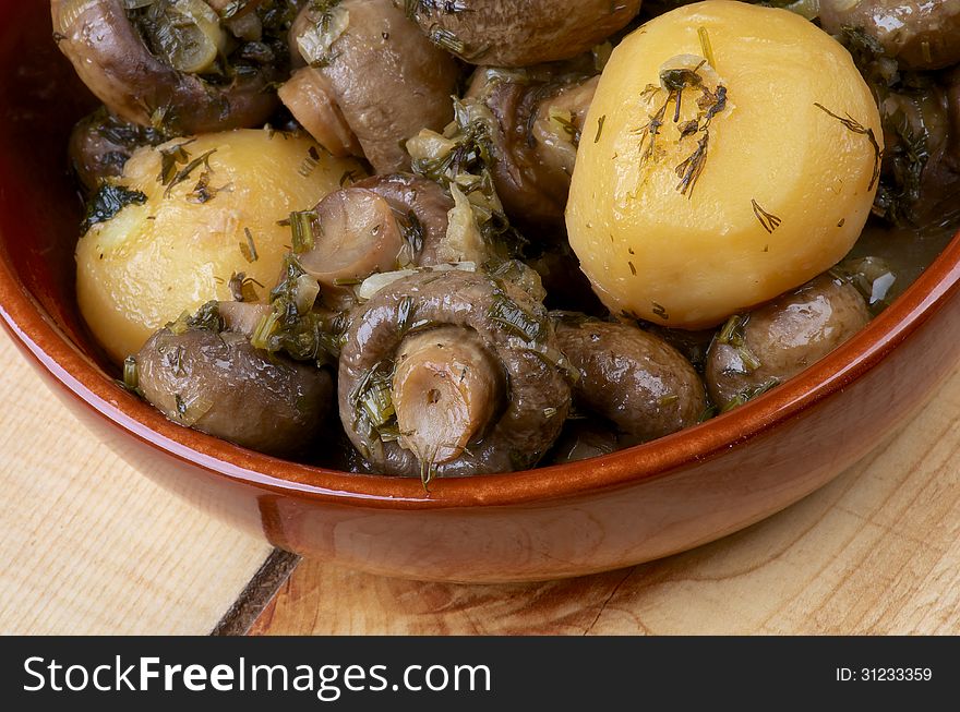 Delicious Stew with Champignon Mushrooms, Roasted Potato, Dill, Parsley, Leek and Onion in Bowl closeup on Wooden background. Delicious Stew with Champignon Mushrooms, Roasted Potato, Dill, Parsley, Leek and Onion in Bowl closeup on Wooden background