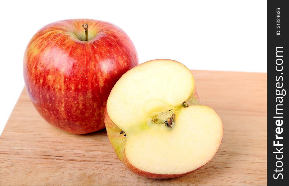 One and a half apple on wood cutting board