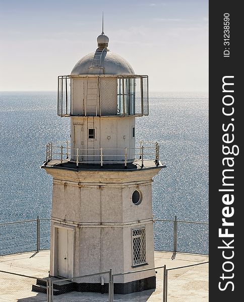 Close up of white lighthouse on sea background