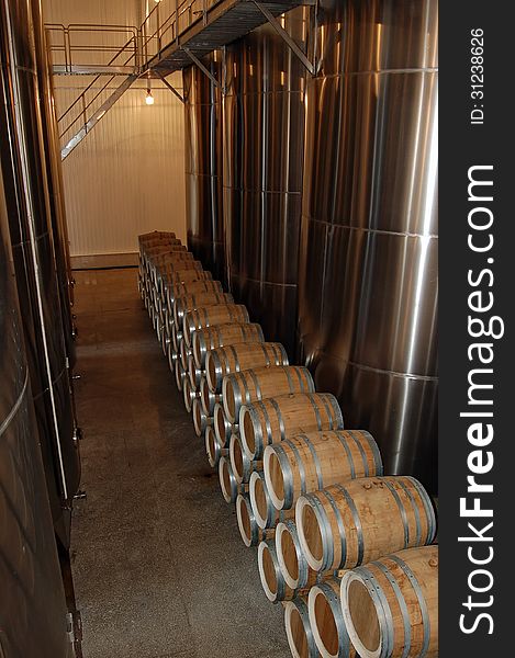 Tanks and barrels of brandy in wine cellar. Tanks and barrels of brandy in wine cellar