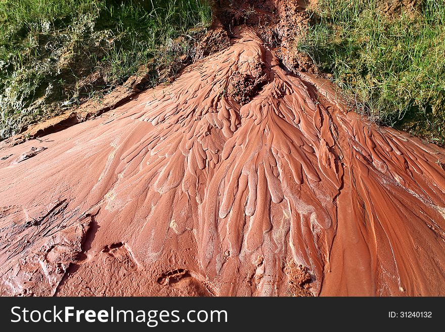 Wet red sand. Water has etched a pattern into sand. Ham Tien canyon in Vietnam