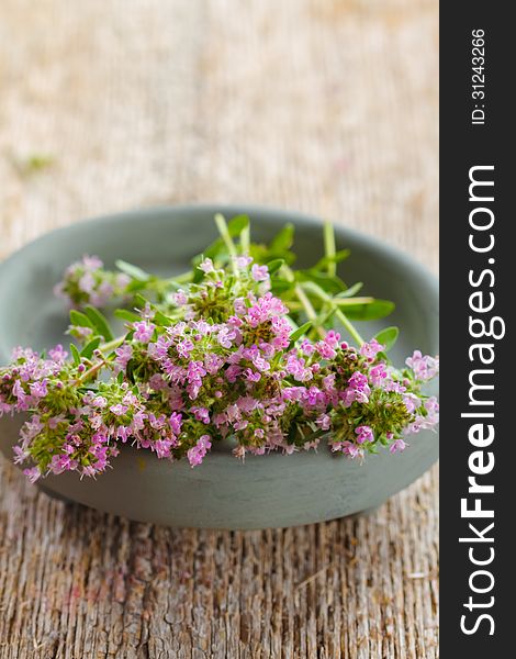 Fresh bunch of thyme on wood background