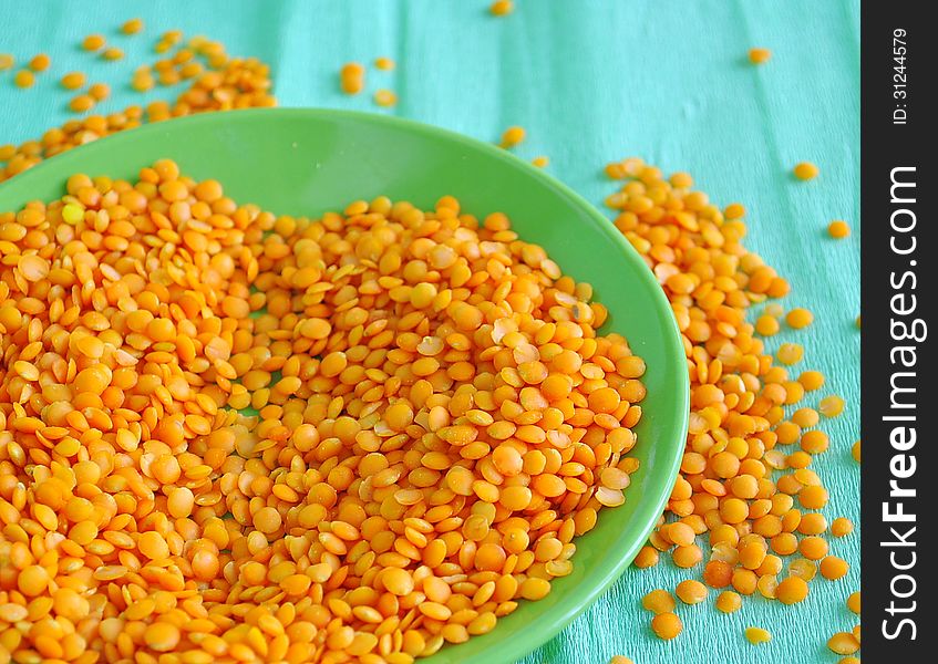 Red lentils on the green background