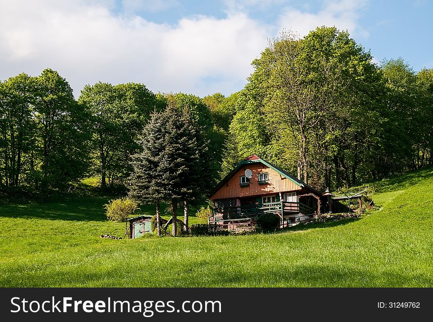 Cottage, meadow and trees