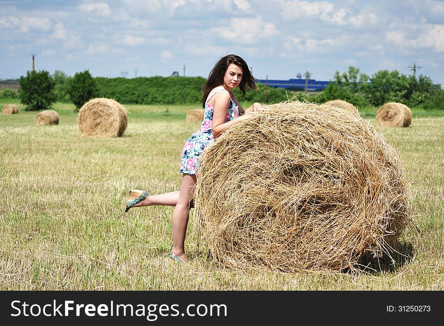 Beautiful girl near haystacks