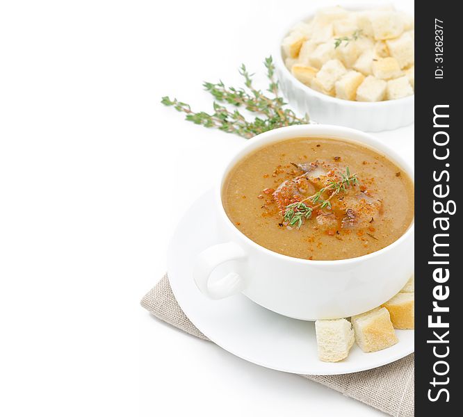 Mushroom cream soup with croutons and thyme isolated on a white background and space for text