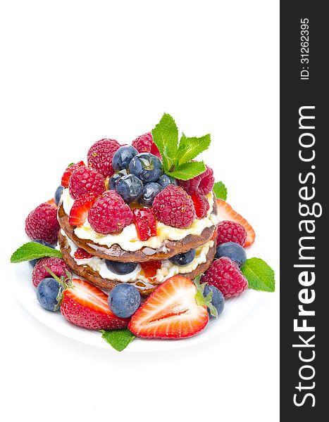 Pancake cake with whipped cream and fresh berries isolated on a white background top view. Pancake cake with whipped cream and fresh berries isolated on a white background top view