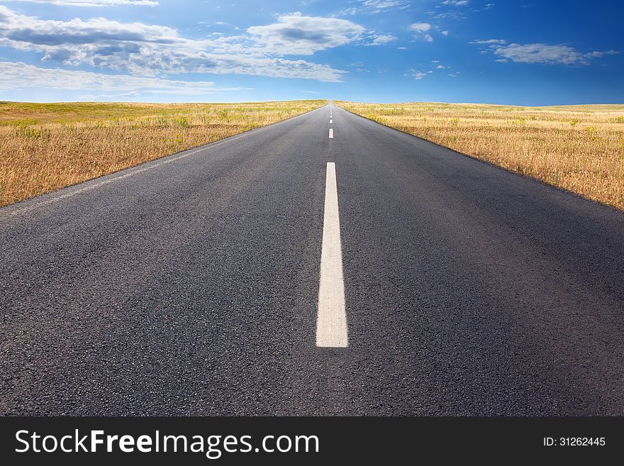 Driving on an empty road at bright sunlight