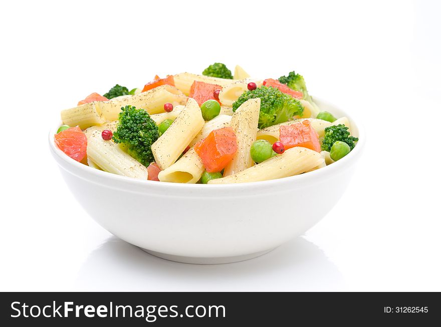 Salad with pasta, smoked salmon, broccoli and green peas in a bowl on a white background. Salad with pasta, smoked salmon, broccoli and green peas in a bowl on a white background