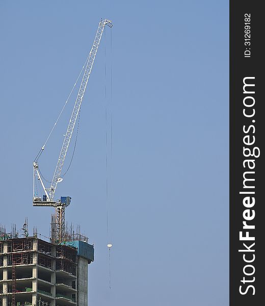 Cranes work for lifting tool at top of high building. Cranes work for lifting tool at top of high building