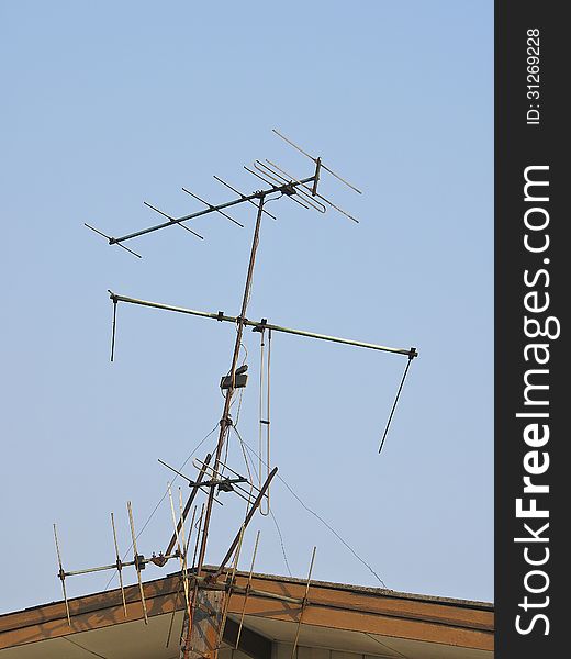 Television antenna on gable house in sunlight