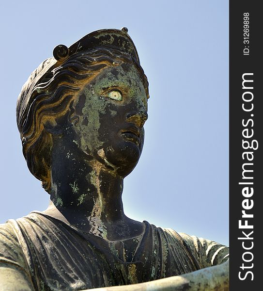 Ancient Roman bronze statue of Diana against blue sky in the Temple of Apollo, Pompeii, Italy. Ancient Roman bronze statue of Diana against blue sky in the Temple of Apollo, Pompeii, Italy