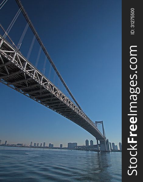 A bridge hanging over Tokyo Bay is photographed by the bottom. The name of this bridge is Ranbow bridge. A bridge hanging over Tokyo Bay is photographed by the bottom. The name of this bridge is Ranbow bridge.