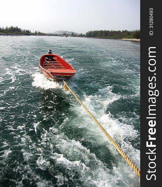 Small boat in sea with landscape background