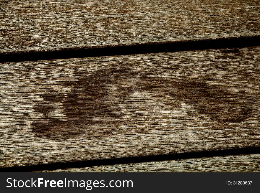 Wet Footprint closeup on Wooden plank background