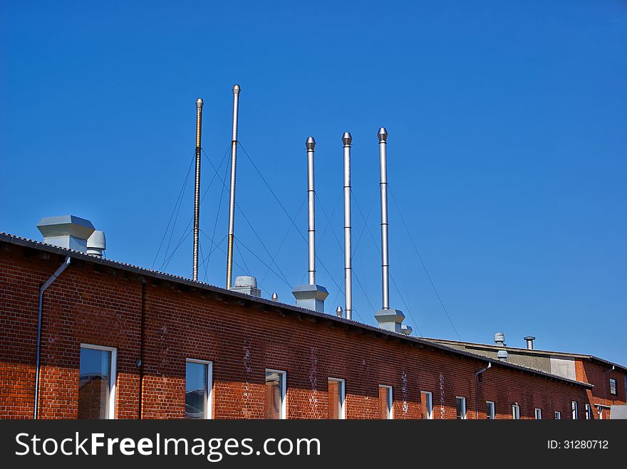 Factory plant industry chimney with clear blue sky behind - Industrial background image