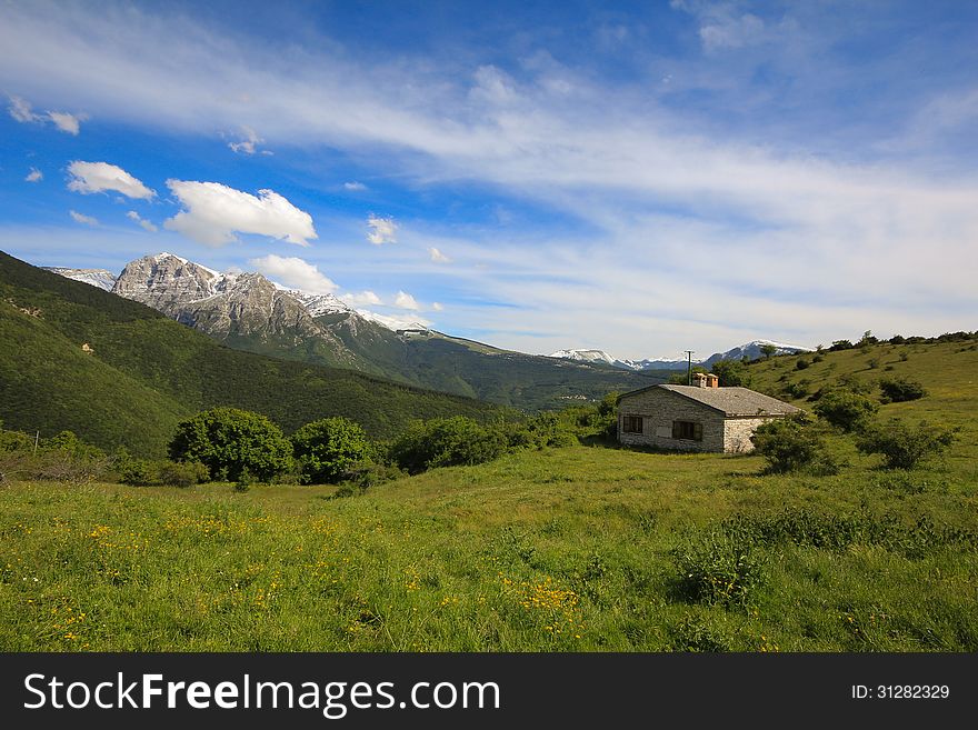 A view of italian alps with isolated house