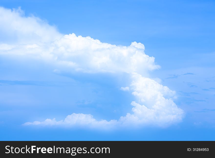 Blue sky background with a tiny clouds.