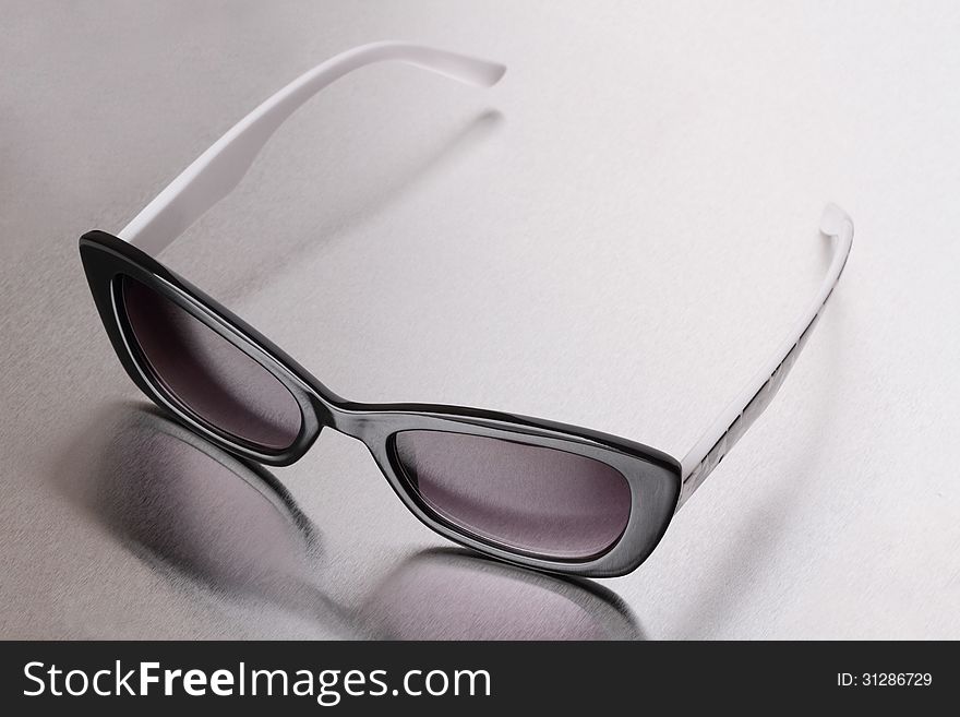 Sunglasses on a gray metallic background