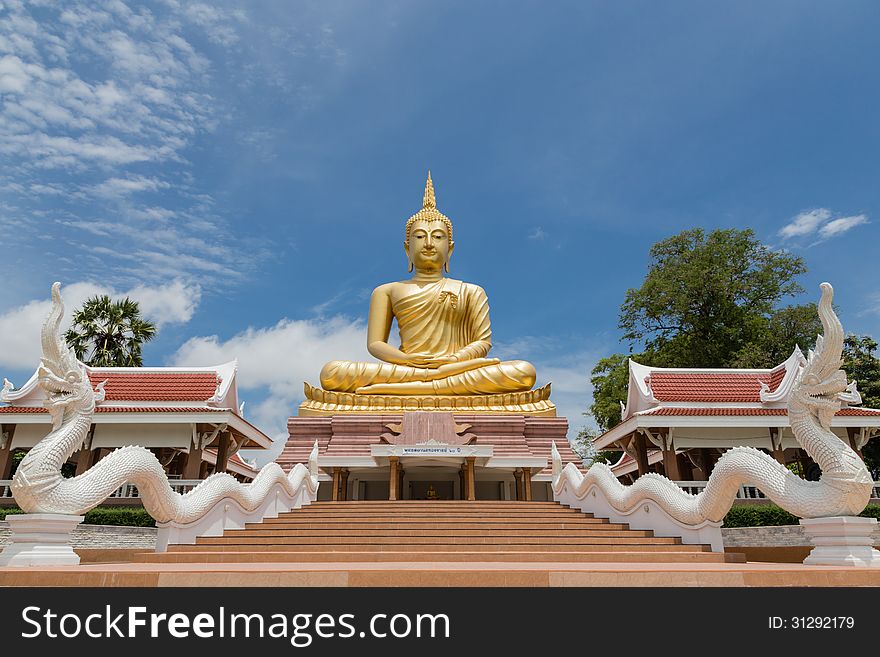 Big golden buddha against blue sky. Big golden buddha against blue sky