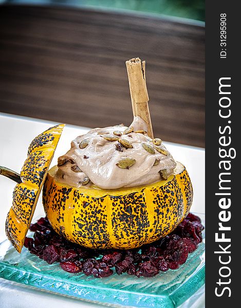 Chocolate pumpkin mousse on top of dried cranberries. with dried pumpkin seeds